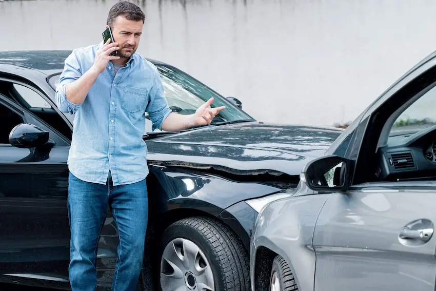 Man On Phone After Car Accident