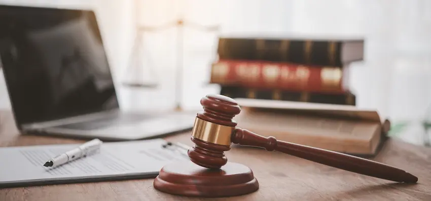 Car accident settlements documentation with a legal gavel and case files on an attorney's desk.