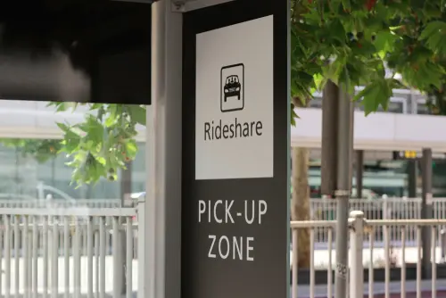 Rideshare pickup zone sign, rideshare accident lawyer concept