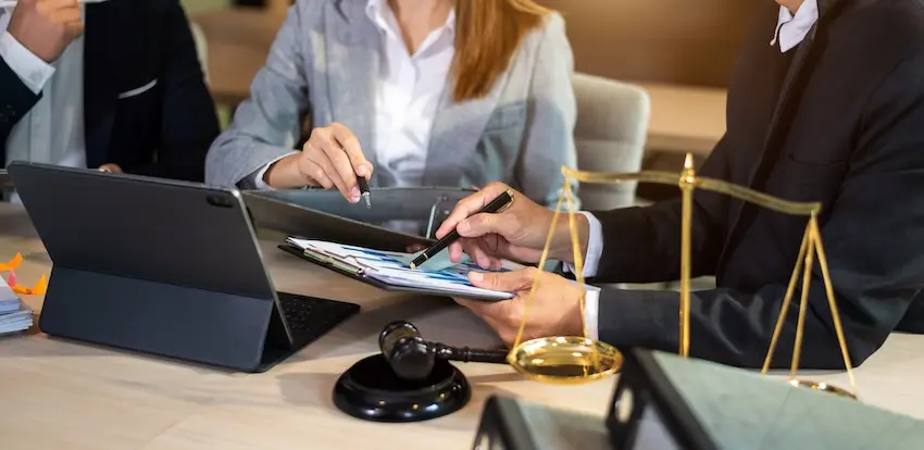 A Mogy Law truck accident lawyer reviewing a client’s case and discussing legal options in an office setting