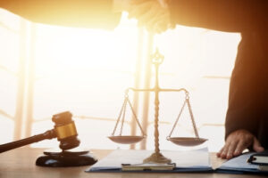 A lawyer from Mogy Law shakes hands with a client after winning a car accident claim.