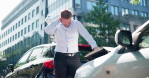 A man experiencing neck pain after a car accident and now seeking a car accident attorney to file a claim for damages.