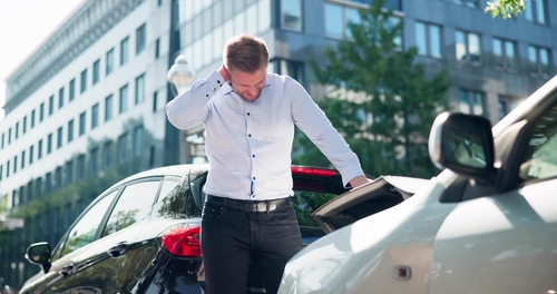 A man experiencing neck pain after a car accident and now seeking a car accident attorney to file a claim for damages.